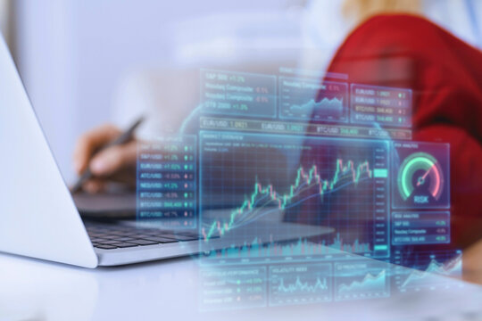 Financial chart hologram displayed over a business laptop