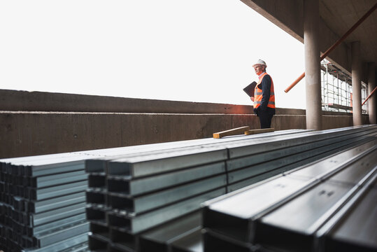 Man wearing safety vest in building under construction