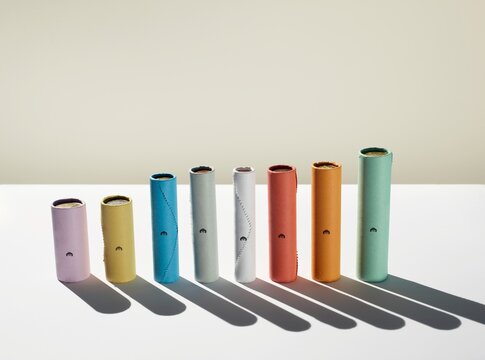 Colorful cylinder rolls forming a financial bar chart with shadows