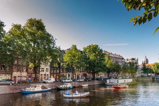 Amsterdam canal view with boat and historic building at Geldersekade