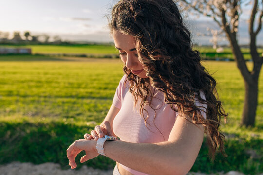 Woman tracking progress on smart watch after exercising