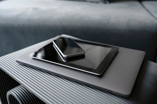 Stack of modern electronic devices on a table indoors