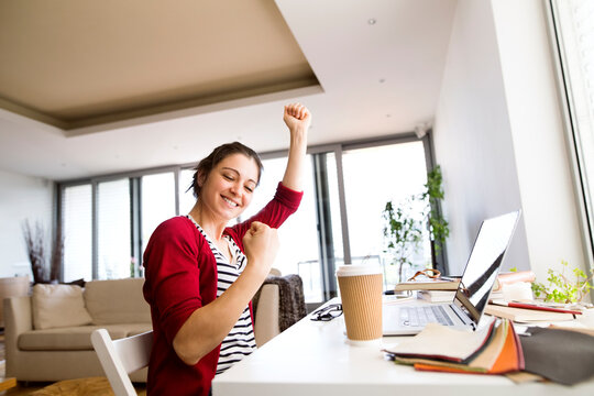 Happy woman at desk at home