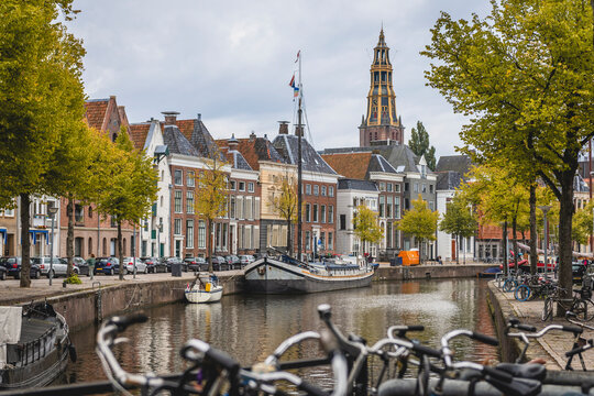 Netherlands, Groningen, City canal with row of townhouses in background