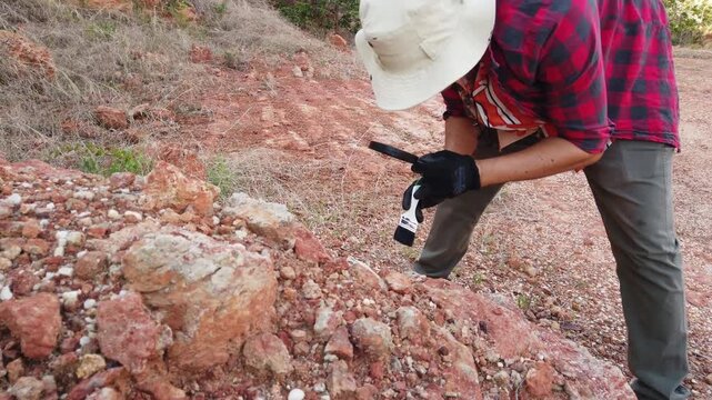 Close inspection with a magnifying loupe helps identify subtle textures on the dinosaur skull