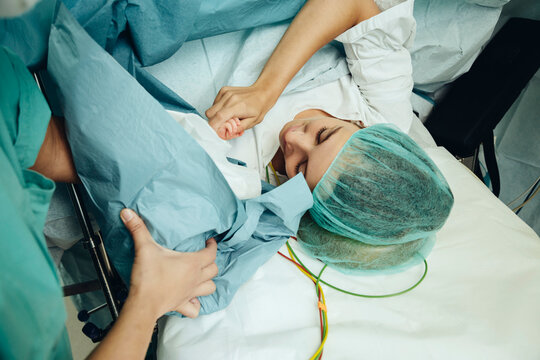 Mother touching her newborn right after c-section
