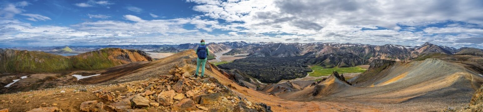 Hiker on the Laugavegur trekking trail, Laugavegur trekking trail, Dramatic volcanic landscape, Colourful erosion landscape with mountains, Lava field, Landmannalaugar, Fjallabak nature reserve, Su&eth;urland, Iceland