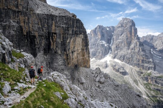 Three mountaineers on a hiking trail, rocky mountain landscape, Via Ferrata SOSAT via ferrata, Brenta Mountains, Trentino, Italy