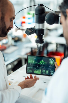 Scientist evaluating medical data on tablet in laboratory