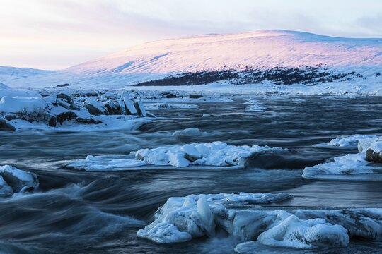 Ice blocks in the river Skalfandafljot at dawn, near the waterfall Godafoss, snow-covered landscape, Northern Iceland Eyestra, Iceland