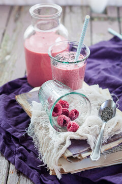 Glass and bottle of vegan raspberry smoothie
