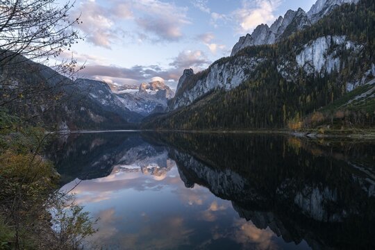 The Vordere Gosausee lake in autumn with a view of the Dachstein mountain range. The Gosaukamm on the right. Good weather, blue sky, a few clouds. In the evening, at sunset. Reflection. Vorderer Gosausee, Gosau, Gosau valley, Salzkammergut, Upper Austria, Austria