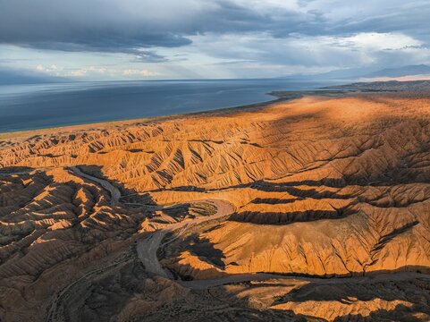 Evening mood, Canyon runs through landscape, Issyk Kul Lake, Dramatic barren landscape of eroded hills, Badlands, Canyon of the Forgotten Rivers, Issyk Kul, Kyrgyzstan