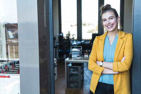 Confident businesswoman standing in modern startup office