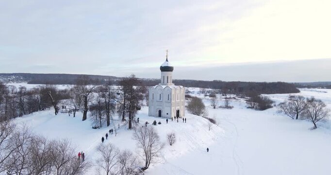 Cinematic aerial drone pedestal shot rising up over the historic Church of the Intercession on the Nerl in winter