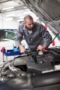 Car mechanic at work in repair garage