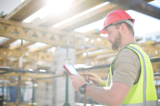 Construction worker using digital tablet on construction site