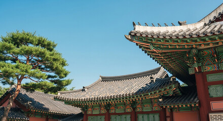 Obraz premium Traditional Korean Architecture Featuring Ornate Tiled Roofs with Dancheong Patterns and Pine Tree in Seoul