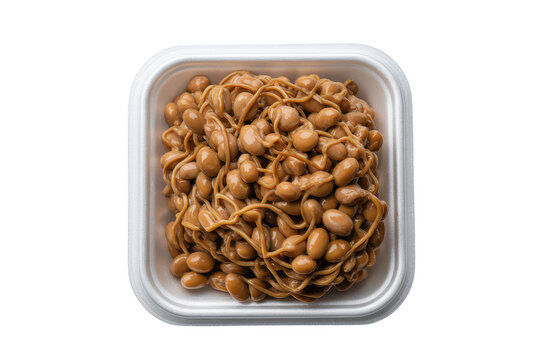 A white plastic container filled with fermented soybeans known as natto, showing a sticky and stringy texture in a top-down studio food