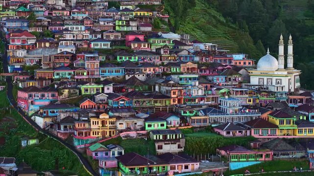 Scenic mountain village with colorful homes on slope, aerial rural landscape surrounded by lush greenery. Nepal van Java village, Indonesia.