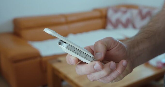 showing a hand pushing a vintage flip phone upward to open it. Suitable for retro technology, mobile communication, old devices, nostalgia, and classic electronics concepts.