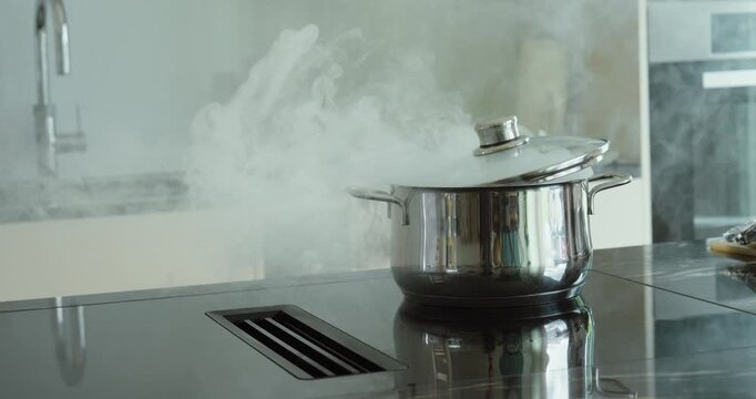 cooking pot producing heavy smoke on a kitchen stove, representing overheating, cooking accidents, fire hazards, smoke emergencies, and household safety risks.