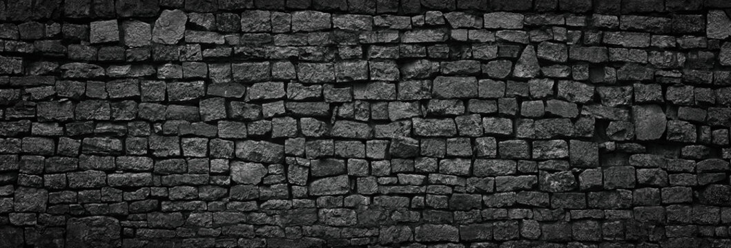 black stone wall an old castle, dark background of slate bricks