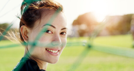 Smile, net and woman on soccer field for fitness, training and positive attitude for match. Portrait, female person and goalkeeper outdoor for football, exercise and practice sports for competition © peopleimages.com