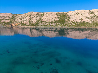 Fototapeta premium Rugged Coastline of Rab Island Reflected in the Adriatic Sea, Croatia