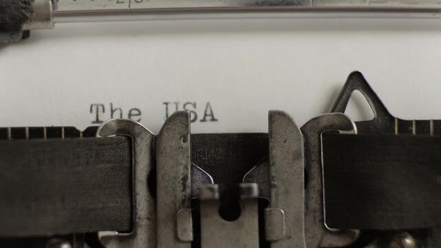 The USA word being typed on old vintage typewriter on white sheet of paper close-up