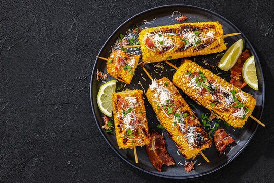 Grilled corn side dish is topped with bacon
