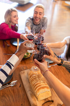 Friends toasting with red wine.
