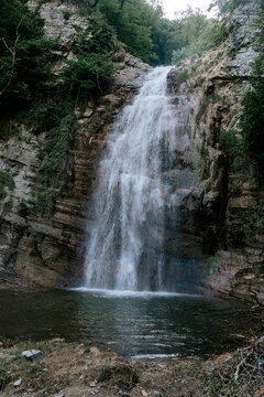 Majestic waterfall cascading into a rocky pool.