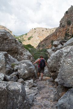 Hiker in in Deads gorge, a gorge and walking track between Zakros and Kato Zakros in eastern Crete island, Greece.