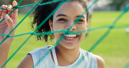 Portrait, net and woman on soccer field for fitness, training and positive attitude for match. Smile, female person and confidence outdoor for football, exercise and practice sports for competition © peopleimages.com