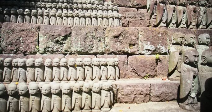 Hundreds of Jizo Stone Statues Arranged on Stone Steps In Japan - Steady Cam