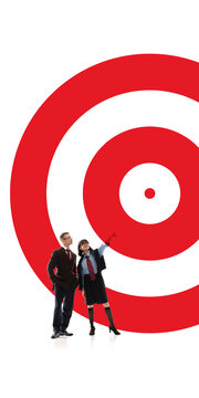 Business team looking toward giant target in goal setting metaphor. Concept of market focus, shared objectives, business ambition, team strategy and performance planning.