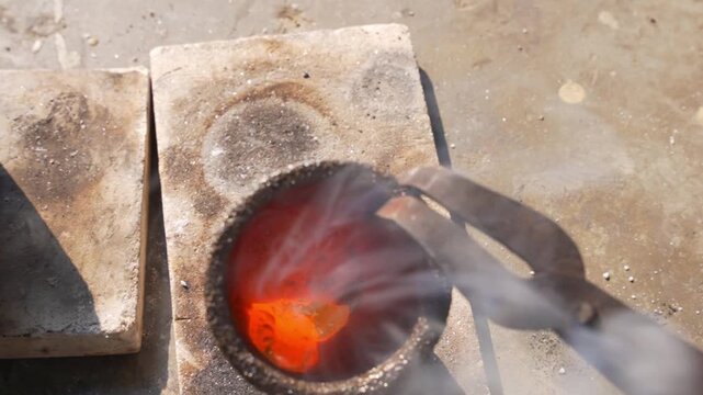 Close up of molten gold in crucible during the refining and casting process in an industrial foundry, showing precious metal production, wealth, investment, and metallurgy concepts