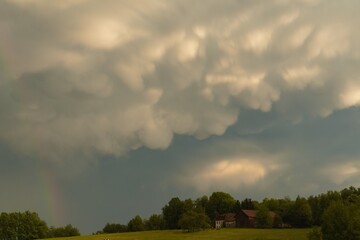 Fototapeta premium Mammatus clouds and rainbow after a thunderstorm