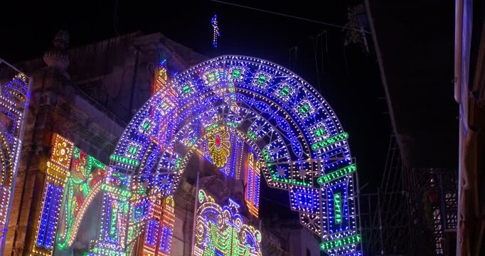 Colorful lights in the shape of an arch in an alleyway in Palermo, night, 4k