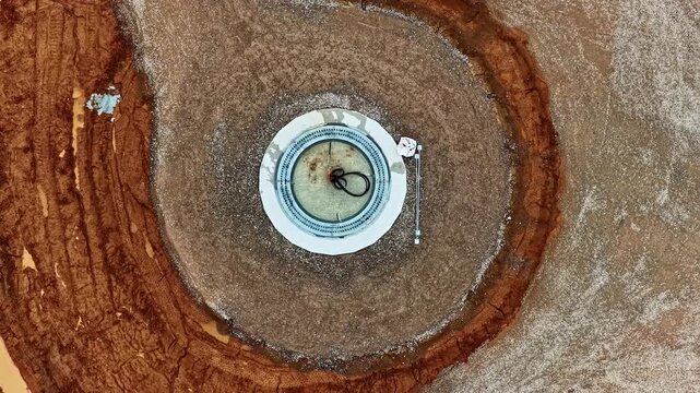 A circular wind turbine foundation surrounded by excavated earth at Augstkalni wind farm. Ideal for construction progress updates or renewable energy projects.