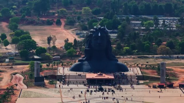 Close-up shot of Adiyogi Shiva statue with Shri Nandeeshwara statue and Shri Yogeshwara Linga Devasthana at Chikkaballapura, Avalagurki, Karnataka, india. day time, push back shot, drone shot, 4k.