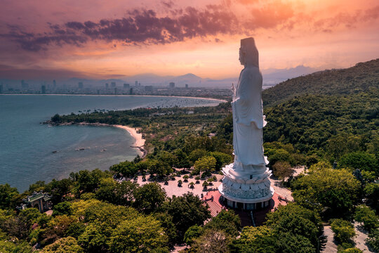 White Buddha statue Lady Buddha at Linh Ung Pagoda, Danang, Vietnam in sunset beautiful clouds