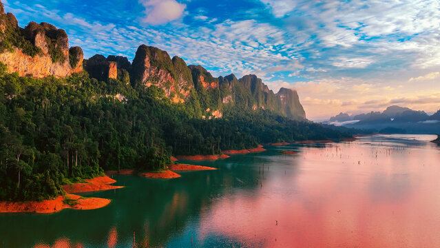 The green area at Khao Sok national park Cheow Lan Dam lake with blue sky background in Surat Thani, Thailand