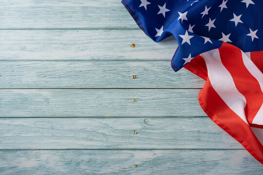 American flag on weathered blue wood background for USA Independence Day celebration and patriotic decor