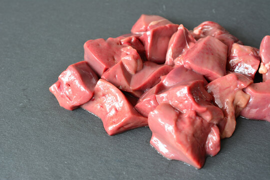 Raw turkey Liver Cubes on Dark Background copy space