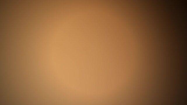 Abstract warm gold and brown blurred radial gradient background template in horizontal orientation