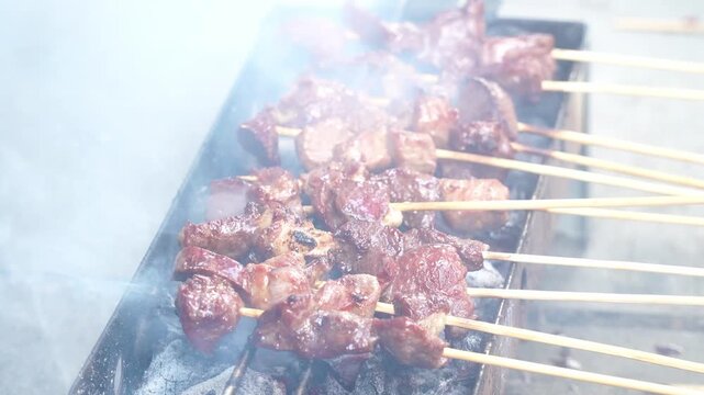 Cinematic Close-up of Smoky Mutton Satay Grilling on Charcoal