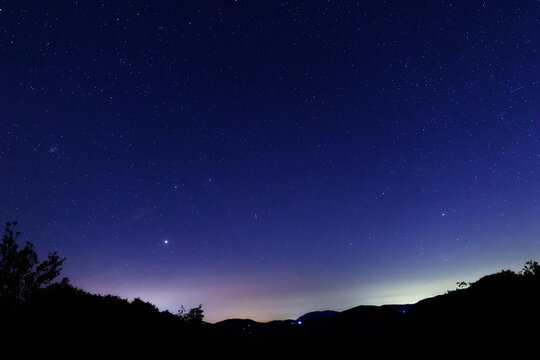 Constellations, landscape, Milky Way stars on a dark countryside skies.