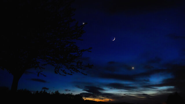 Crescent Moon, planet conjunction and landscape scenery silhouettes.